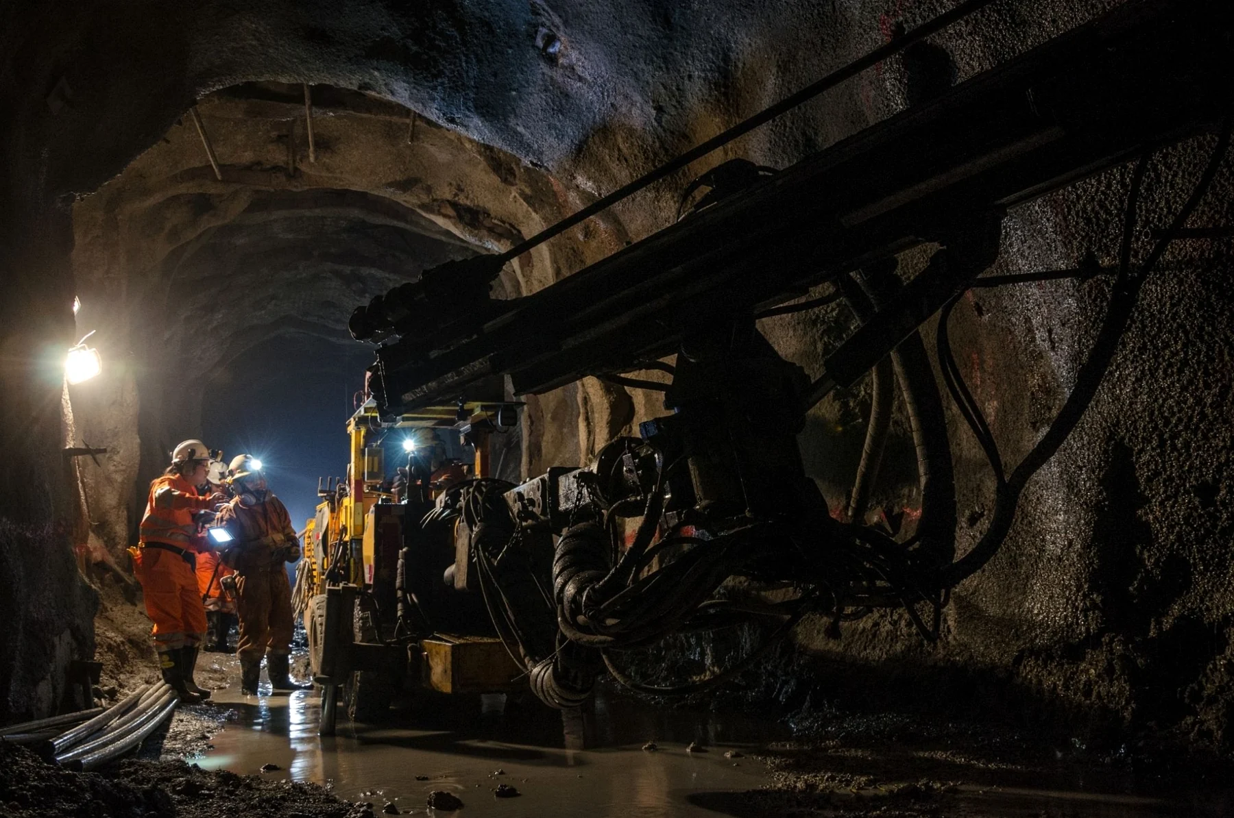 Mining crew working near underground machinery